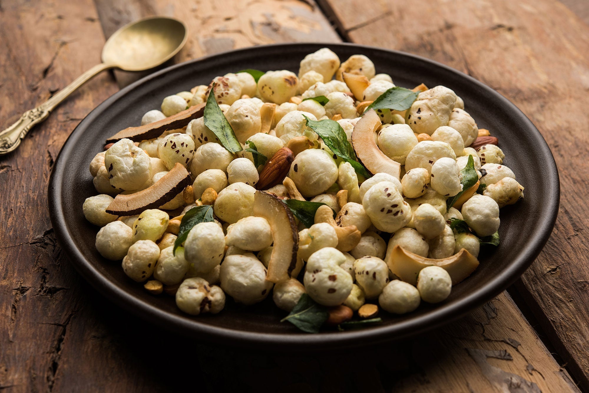 Roasted makhana with nuts, coconut and curry leaves
